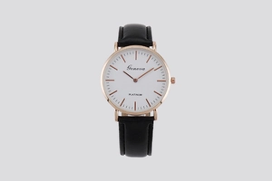 Close-up of Geneva quartz watch featuring rose gold case and black leather strap details