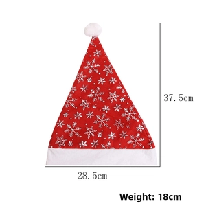 Detail view of red Christmas hat with white snowflakes and plush ball, size 37.5cm x 28.5cm