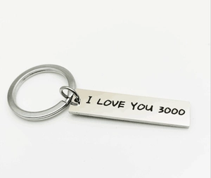 Close-up of polished stainless steel keychain engraved with I LOVE YOU 3000 text