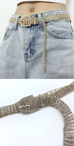 Detail shot of luxury ten-row rhinestone belt with sparkling crystals on gold metal mesh