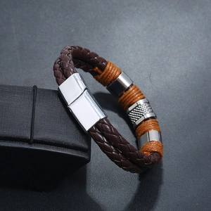 Macro shot of men's braided leather bracelet with steel beads and magnetic clasp