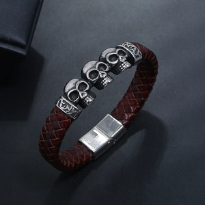 Retro brown braided leather bracelet with silver skull charms and a secure metal clasp