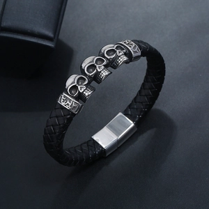 Men's braided leather bracelet with silver skull beads and magnetic clasp