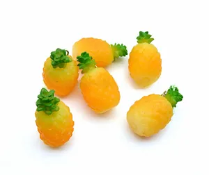 Detail of PVC pineapple keychains with realistic texture and metallic rings