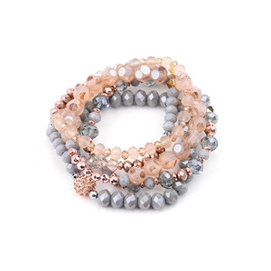 Macro shot of 4-piece multilayer beaded bracelet set with crystals and pave ball charm