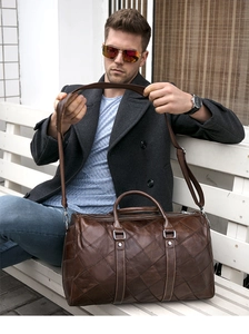 Brown leather travel duffel bag with diamond pattern shown in professional lifestyle scene