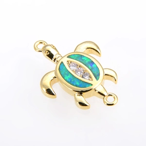 Detail of gold turtle connector with blue-green opal and clear zircon stones