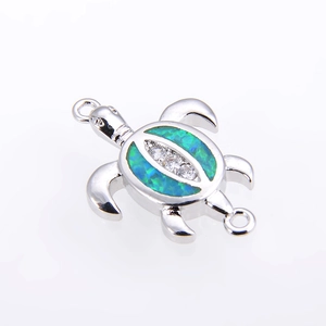 Detailed view of silver turtle connector with teal opal inlay and sparkling zircons