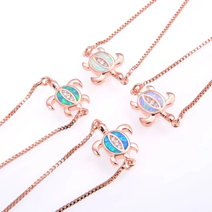 Detailed view of four rose gold turtle bracelets with blue opal stones and zircon accents