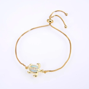 Close-up of golden turtle bracelet with opal inlay and adjustable box chain