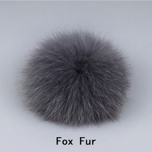 Macro shot of fluffy dark grey fox fur pom pom with soft texture and clear hair details