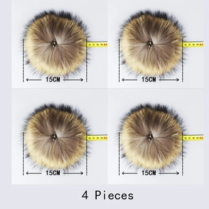 Detail of 4 pieces 15cm natural raccoon fur pom-poms for hats and apparel decoration