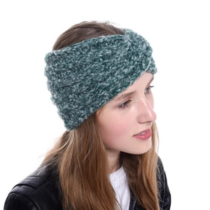 Close-up of deep green chunky knit twisted headband for women showing thick texture