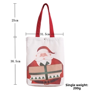 Detail view of canvas Santa gift bag with red handles and festive cartoon print