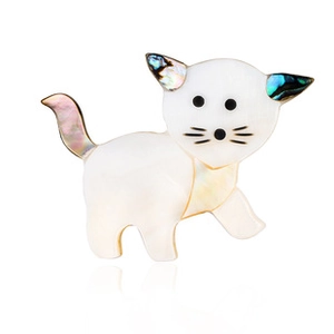 Detail of white shell cat brooch with colorful abalone inlay on ears and tail