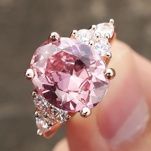 Rose gold plated ring featuring oval pink crystal and clear accent stones