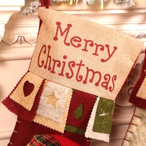 Premium burlap Christmas stocking with Merry Christmas print on a white fireplace