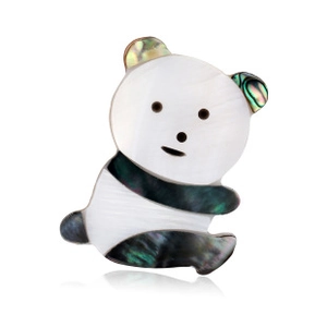 Detailed view of panda brooch featuring white mother of pearl and abalone shell texture