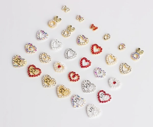Detailed view of 520 heart and bunny ear nail art charms with rhinestones and pearls
