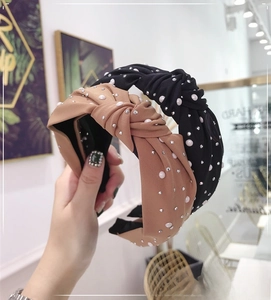 Detail of knotted headbands with pearls and rhinestones in black and camel tones