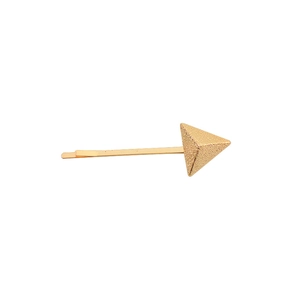 Macro detail of golden geometric triangle hair clip with textured metallic finish