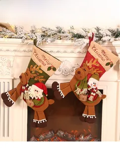 Detail of plush Christmas stockings with 3D reindeer figures and Merry Christmas embroidery