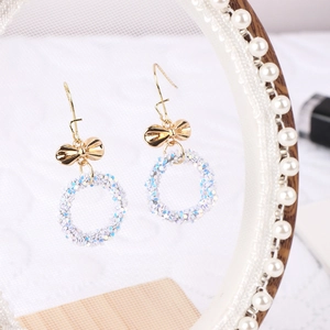 Lace earring display stand with golden bow-knot sequin hoop earrings for jewelry photography