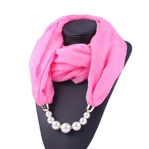Pink chiffon jewelry scarf with white pearl necklace beads on a black mannequin display