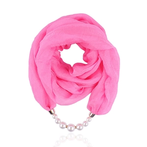 Detail view of pink chiffon neckerchief featuring a gradient pearl necklace and gold accents