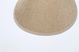 Detailed macro view of khaki woven straw sun visor showing fine cotton linen texture