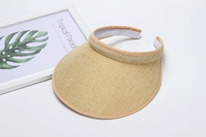 Detail of khaki straw sun visor showing internal absorbent lining and woven texture