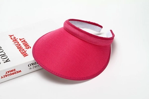 Detail of rose red sun visor showing breathable mesh fabric and sweat-wicking inner band
