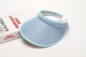 Close-up of light blue woven sun visor with internal sweatband and refined texture