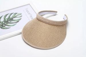 Detail of wide brim sun visor with straw texture and inner sweatband for summer comfort