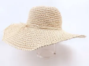 Handmade hollow wide brim straw hat in cream white for summer UV protection