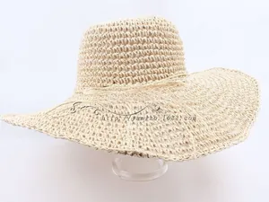 Close-up of hand-woven hollow straw hat texture with wavy wide brim for summer sun protection