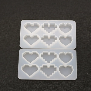 Detail of pixel heart silicone mold for resin casting with 6 cavities on black background