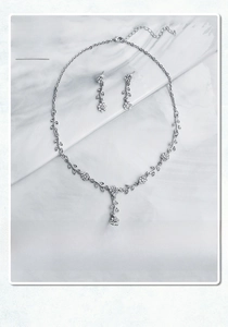 Detailed view of silver floral bridal necklace and earring set with shimmering crystals