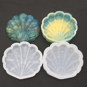 Detailed view of shell-shaped silicone molds and gradient resin jewelry storage boxes