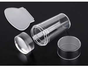 Detailed view of clear silicone nail art stamper and scraper set on black background