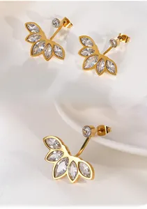 Detailed macro view of gold fan-shaped earrings with marquise-cut zircon stones