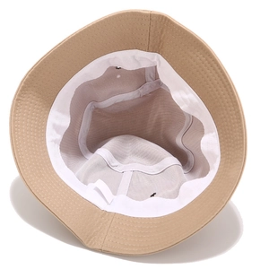 Inside view of a beige cotton canvas bucket hat showing stitching and sweatband