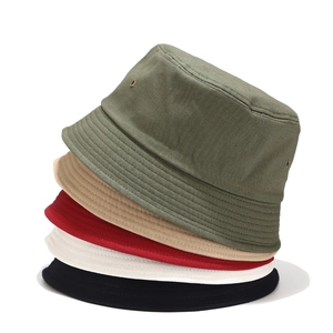 Detail of stacked cotton bucket hats in green, khaki, red, white, and black colors