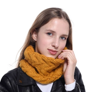 Detail of chunky cable knit texture on ginger orange acrylic winter headband scarf