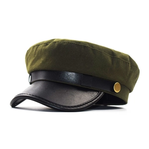 Detail of olive cotton military cap with black leather visor and gold metal button