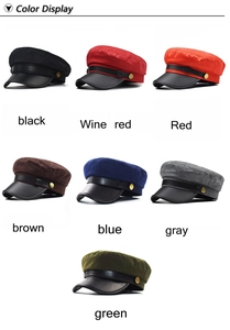 Multi-color display of wool blend baker boy caps with PU leather brims and metallic buttons