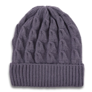 Detail shot of the thick cable knit texture and ribbed cuff on a dusty purple winter beanie