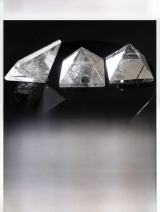 Detailed view of natural white crystal pyramid with internal textures and reflective finish