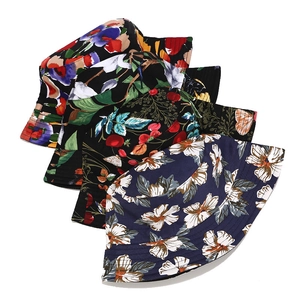 Detail view of cotton bucket hats with floral, cherry, and abstract print patterns