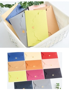 Detailed view of colorful scalloped edge envelopes with creative heart-shaped clasp closures